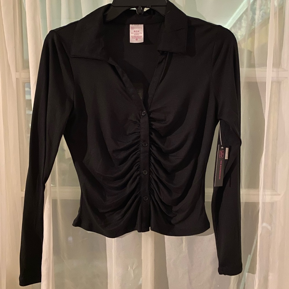 Girl’s black top with pulled front for a beautiful look.